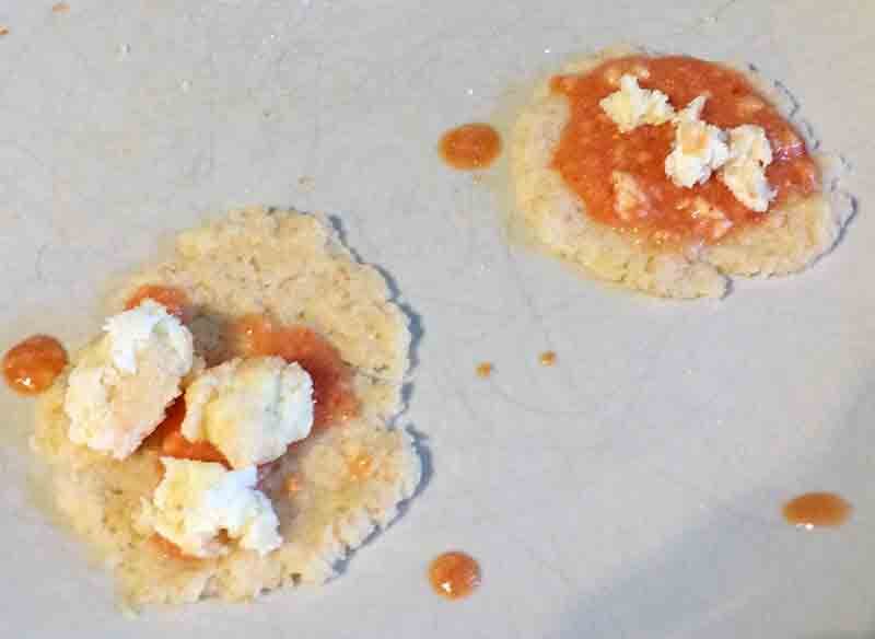 pizza bases with sauce and cheese